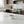 Luna Pedestal Dish Alba Lunarie filled with nuts sits on a white marble kitchen island next to a glass of red wine, with a modern kitchen in the background.