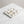 Selene Crest Tray by Lunarie featuring a sculptural wave design and minimalist finish, ideal as a decorative catchall tray for jewelry and home decor with gold necklace on a marble surface