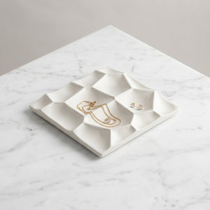 Selene Crest Tray by Lunarie featuring a sculptural wave design and minimalist finish, ideal as a decorative catchall tray for jewelry and home decor with gold necklace on a marble surface