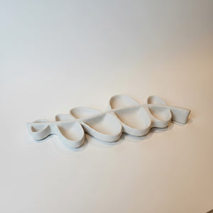 Vine Leaf Dish Lunarie Alba multi-compartment dish rack with organic, flowing shapes, shown against a plain off-white wall.