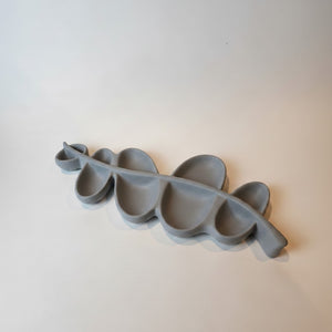 A modern, Vine Leaf Dish Lunarie moon ash dish holder with multiple wavy compartments, photographed on a clean, light off-white background.