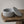 Astral Nock Jar by Lunarie featuring a textured white finish and matching lid, ideal as a decorative storage jar for jewelry and home essentials. Textured grey concrete container with lid on a wooden surface