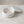 Astral Nock Jar by Lunarie featuring a textured white finish and matching lid, ideal as a decorative storage jar for jewelry and home essentials with jewelry on a marble surface