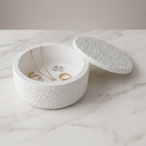 Astral Nock Jar by Lunarie featuring a textured white finish and matching lid, ideal as a decorative storage jar for jewelry and home essentials with jewelry on a marble surface