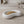 Crescent Dish by Lunarie featuring a smooth crescent moon-inspired shape and matte finish, ideal as a jewelry catchall dish and decorative home accent. place it  with pistachios on a wooden surface