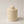 Decorative Cement jar with small pumpkin on top , on a light grey  background 