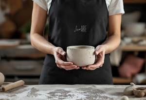 Person holding a concrete bowl in a pottery studio