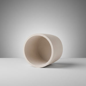 Moon Hollow Tumbler Jar by Lunarie featuring a minimalist cylindrical design with lid, ideal as a decorative storage jar for jewelry and home essentials. Beige concrete jar on a gray background