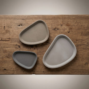 Moon Layers Trio by Lunarie featuring three nesting decorative trays with organic shapes, ideal for jewelry, candles, and modern home décor on a wooden surface
