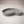 Moonlit Arc Tray by Lunarie featuring an elegant organic shape and minimalist matte finish, ideal as a decorative catchall tray for jewelry and home décor. Gray wavy concrete dish on a beige background