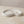 Moonlit Arc Tray by Lunarie featuring an elegant organic shape and minimalist matte finish, ideal as a decorative catchall tray for jewelry and home décor gold necklaces and rings on a marble surface