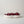 Nest Centerpiece Bowl by Lunarie featuring an organic sculptural shape with flowing curves, ideal as a decorative centerpiece bowl for modern home décor.  filled with red cherries on a light gray background