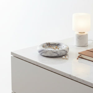 Noir Blanc Vein Marble Trinket Dish by Lunarie made from natural white marble with black veining Marble-patterned jewelry dish on a white surface with a lamp and notebook in the background
