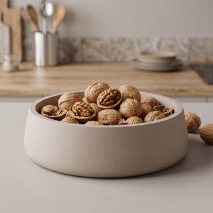 Orbit Bowl by Lunarie featuring a minimalist rounded design and matte finish, ideal as a decorative catchall bowl for jewelry and modern home décor.  filled with walnuts on a kitchen counter