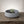 Orbit Bowl by Lunarie featuring a minimalist rounded design and matte finish, ideal as a decorative catchall bowl for jewelry and modern home décor. with air plant on a wooden surface