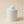 Decorative Cement jar with small pumpkin on top , on a beige background 